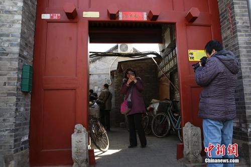 资料图:2月27日,游客在南锣鼓巷雨儿胡同30号前拍照留念。<a target='_blank' href='http://www.chinanews.com/' _fcksavedurl='http://www.chinanews.com/'></table>中新社</a>发 熊然 摄